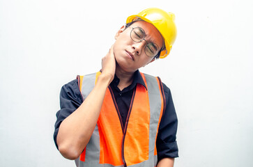 young asian male construction worker using yellow helmet and orange vest do stretching after hard...