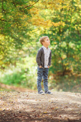 portrait of a blond boy outside in natural light, the boy staring straight into the camera