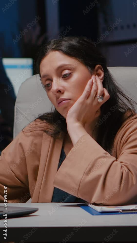 Poster portrait of exhausted workaholic manager checking economic statistics using laptop computer while si