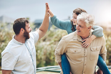 High five, grandfather and father with girl child walking in nature with piggyback ride. Happy,...