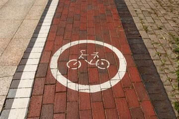 Bike path. Traffic sign for bicycles on paving stones.