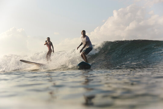 Couple with surfboards in an ocean
