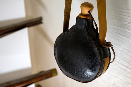 An old powder horn made of black leather, a close-up photo.