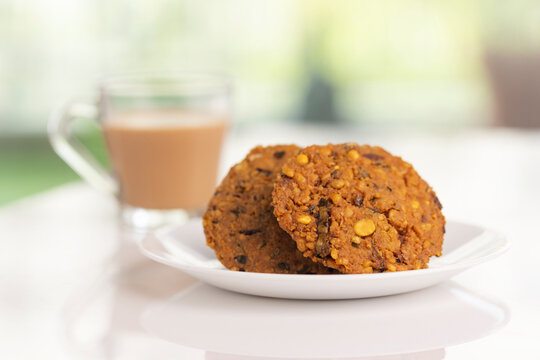 Indian Snack Peas Masal Vada, deep fried snacks food with cup of tea.