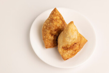 Plate of hot Samosas on table 