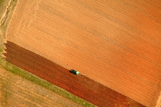 Aerial view of a farmer plowing his fields and creating patterns and textures near Hendersonville, NC.