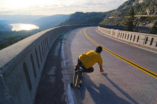 Man skateboarding on road in California.