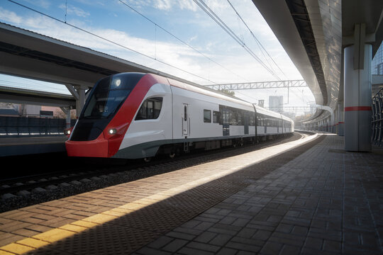City train drive on railroad at the platform train station. Transportation background in sunny day
