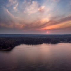 Fototapeta na wymiar Nature landscape, drone aerial top view to green forest and lake at dramatic sky sunset. Istrinskoye Vodokhranilishche