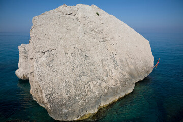 Woman leaps into the ocean, Sardinia, Italy