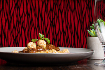 Risotto in beef broth with pieces of tenderloin on top. Rice. Italian food. Meat and rice.