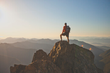 Backpacker standing on mountain peak, North Cascades National Park, Washington State, USA