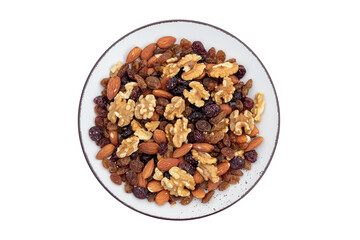 Healthy snack: mixed nuts and dried fruits in ceramic plate isolated on a white background. Almond, walnut, cranberry, raisin. Top view. Vegetarian food concept.