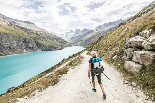Senior hiker near reservoir in Swiss Alps, Haute Route Traverse, Valais Canton, Switzerland