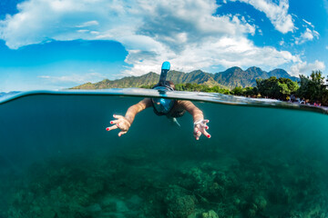 Woman snorkeling,Â Perebutan, Bali, Indonesia