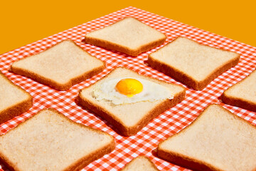 American breakfast. Perfectionism and minimalism. Uncooked bread toasts on plaid red and white tablecloth background. Food pop art photography.