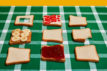 Original composition with uncooked bread toasts on plaid green and white tablecloth background. Vintage, retro style. Food pop art photography.