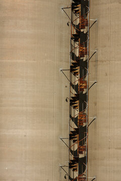 Rusted spiral staircase climbs the exterior of a large concrete silo in downtown Charleston, WV.
