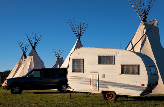 A tepee stands alongside  a camper and truck and an Indian dance in Northern California.