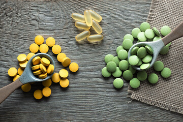 Dietary supplements from natural ingredients with natural plant extracts, yellow and green pills...