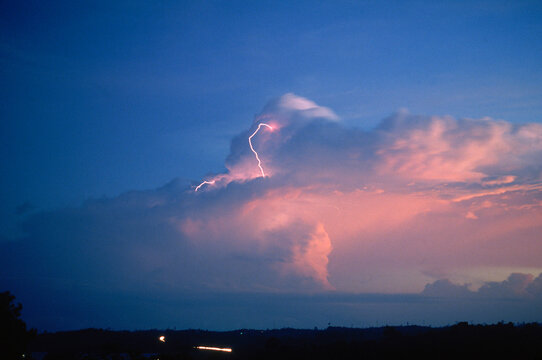 The setting sun illuminates a thunderstorm, Kalimantan, Indonesia