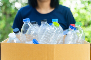 woman sorting garbage, holding carton box full of plastic bottles for preserving saving environment nature protection,Concept of reuse, reduce, recycle to save the environment.