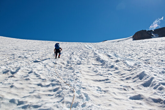 Mountain climber making way up Inter Glacier of Mount Rainier towards Camp Schurman, Mount Rainier National Park, Washington State, USA