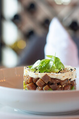 Tuna tartar. Tuna cut into small cubes mixed with soy and spicy and avocado bed

