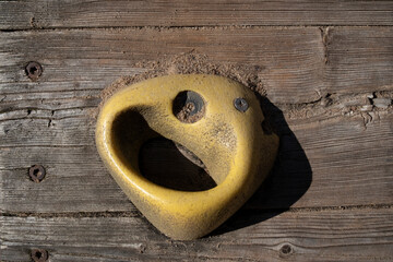 Yellow hold on a artificial indoor climbing wall