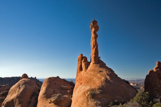 Man Standing On Top Of Desert Rock Spire, Moab, Utah