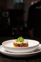 Tuna tartar. Tuna cut into small cubes mixed with soy and spicy and avocado bed

