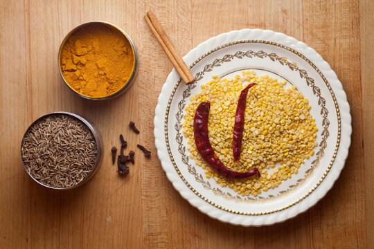 Various Indian spices and split peas sit in bowls on a counter op in a home kitchen in Seattle, Washington.