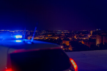 police car with the city in the background