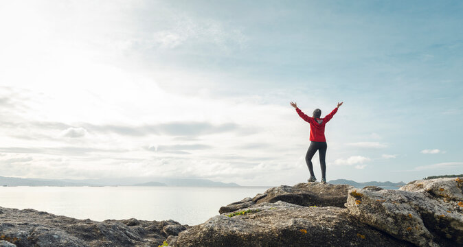 Woman with raised arms enjoying the view