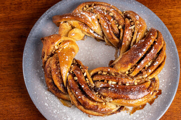 Roscón de reyes Kringle Estonia. Typical Christmas sweet, braided sponge cake with cinnamon, butter, walnuts or almonds and icing sugar.
