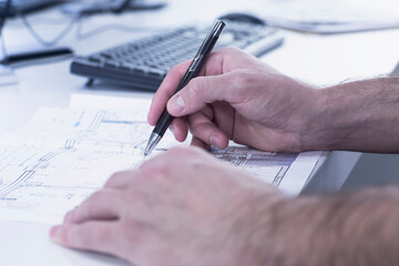 Architect hand drawing blueprint on paper in an office, Freiburg im Breisgau, Baden-Württemberg, Germany