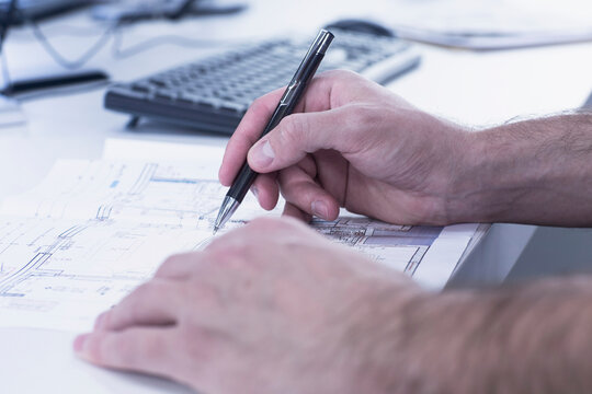 Architect hand drawing blueprint on paper in an office, Freiburg im Breisgau, Baden-W&uuml;rttemberg, Germany