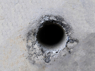 Background texture of cement wall with hole in the middle
