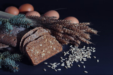 Fresh loaves of bread with wheat and gluten on a black table. Bakery and grocery concept. Fresh,...