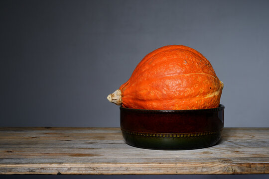 orange Hokkaido pumpkin in a ceramic bowl
