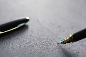 Office supplies on the table. A fountain pen. Business pen in the office on a stone surface.