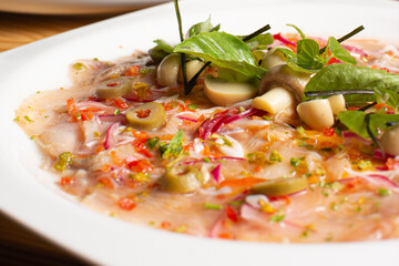 Fish carpaccio. Finely sliced ​​fish. Tuna and needle fish. Garnished with Olive Oil and Capers