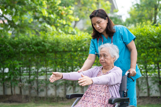 Doctor help Asian senior or elderly old lady woman patient exercise on wheelchair with happy in park. - Powered by Adobe