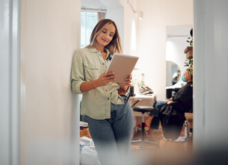 Salon, tablet and beauty hair worker logging small business data and client information. Digital, internet and web research of a hairstylist using technology with a smile proud of entrepreneur growth