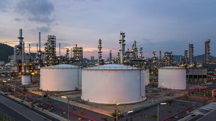 Aerial view oil storage tank and oil refinery factory plant at night form industry zone, Oil refinery and petrochemical plant factory at night, Business oil and gas industrial factory power and energy