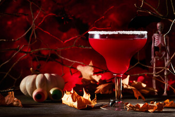 Halloween bloody cocktail margarita. Bloody red cocktail margarita and bottle form skull on scary...