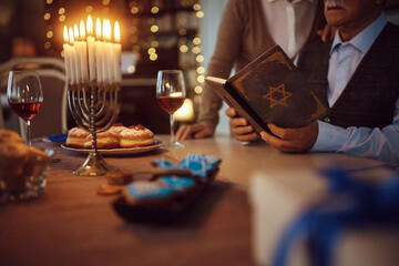 Close up of senior Jewish couple reads Hebrew bible on Hanukkah.