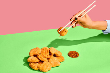 Delicious image of chicken nuggets and french mustard on green tablecloth Eating with chopsticks....