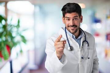 Male doctor pointing at you while standing at isolated background