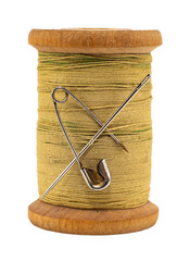 An old wooden spool of thread and a needle on a white background close-up. Threads for sewing